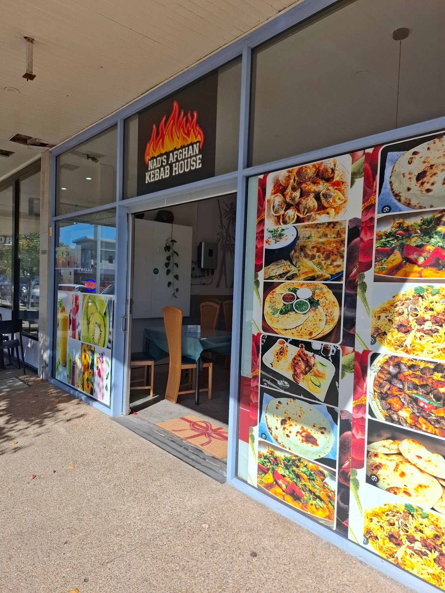 Afghan food spread with biryani, karahi curry, and flatbread at Nad's Afghan Kebab House